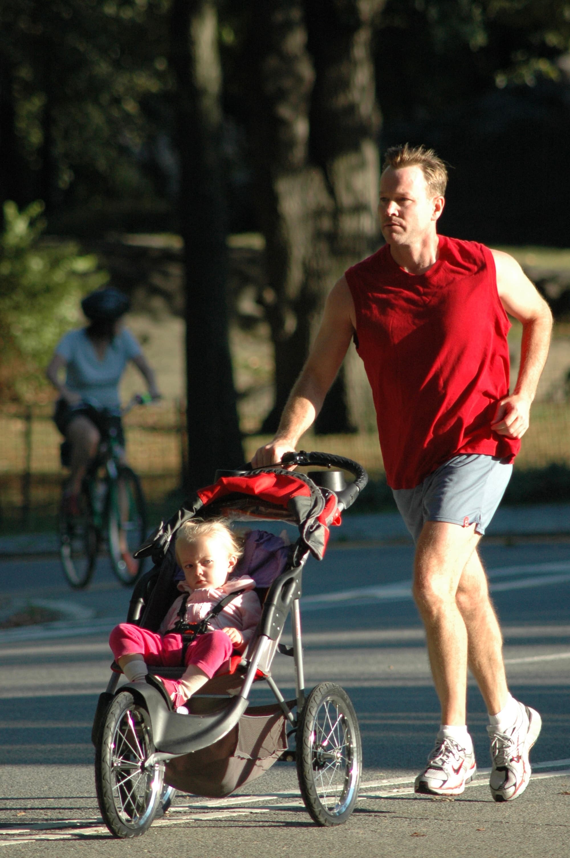 A person pushing a child in a stroller